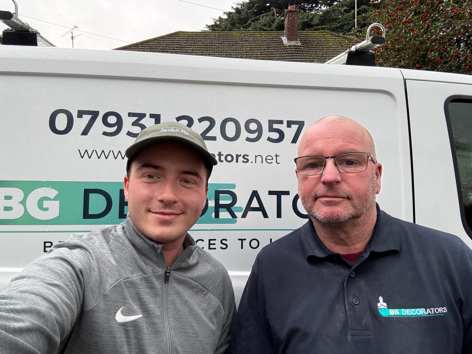 Ash Game and Bill Game of BGDecorators in front of the company van